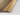 Close up of wood effect aluminium door threshold profile showing grain and finish for flooring transitions