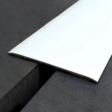 Heavy duty self-adhesive aluminium floor transition strip 60mm installed between same-level dark laminate flooring
