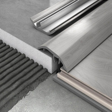 3D render of modern floor transition strips connecting tile and laminate flooring on concrete subfloors. Shows professional threshold profile for smooth and durable floor edge finishing