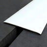 Heavy duty self-adhesive aluminium floor transition strip 60mm installed between same-level dark laminate flooring